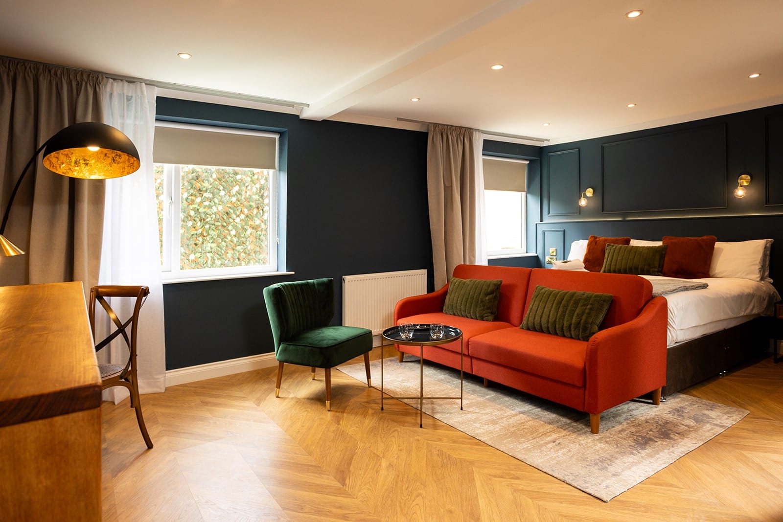 A cozy room featuring a bed, a couch, and a chair