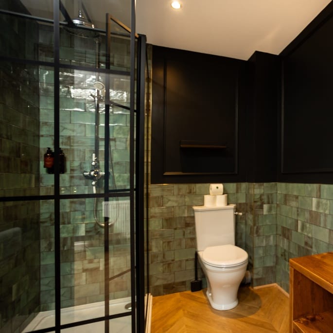 A clean bathroom featuring a toilet and a shower