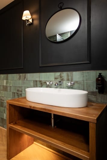 A stylish bathroom with deep black walls