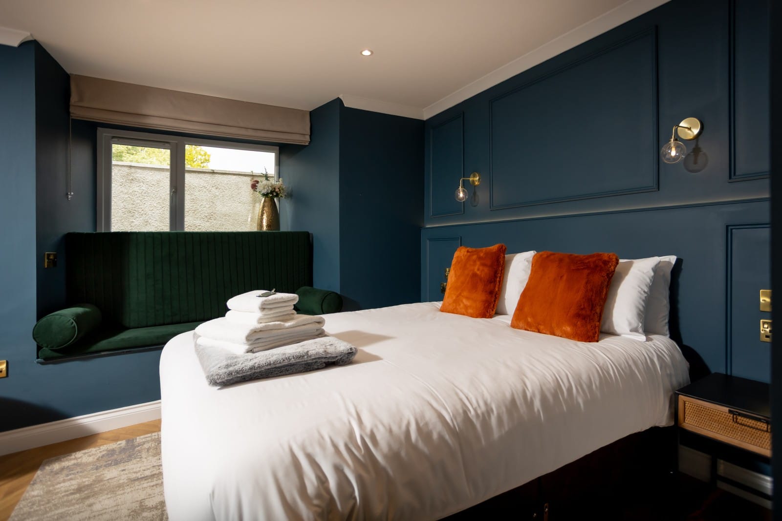 A cozy bedroom featuring blue walls