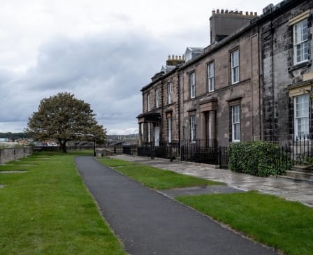 A winding path leads to a row of houses