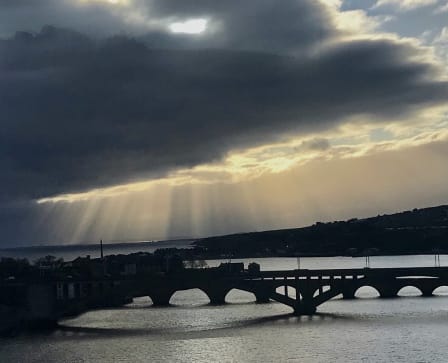 Sunbeams illuminate clouds